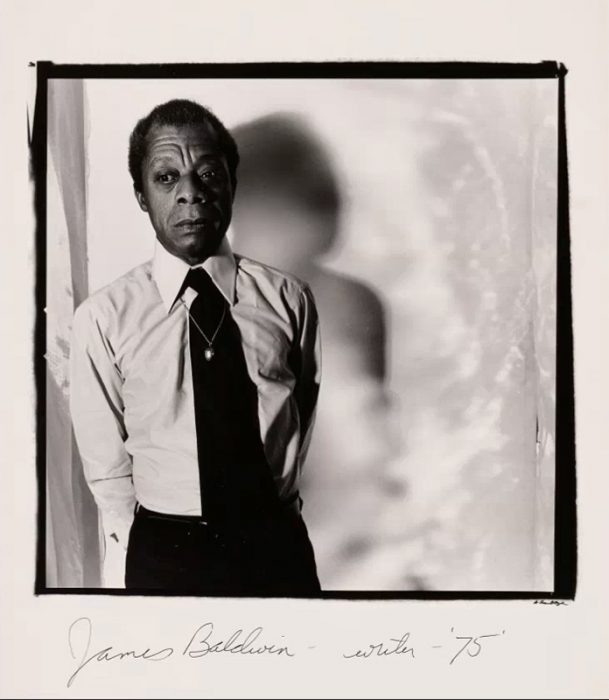 Black and white portrait of Baldwin with handwritten caption