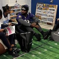 Terrance West listening attentively to two young girls in the Book Nook