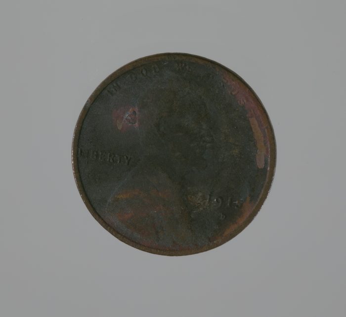 Close up of penny coin showing fire damage