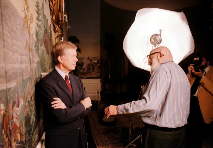 Adams adjusts Carter's posture in preparation for photo shoot.