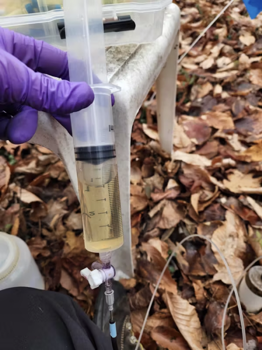 Close up of technician holding vial containing water sample