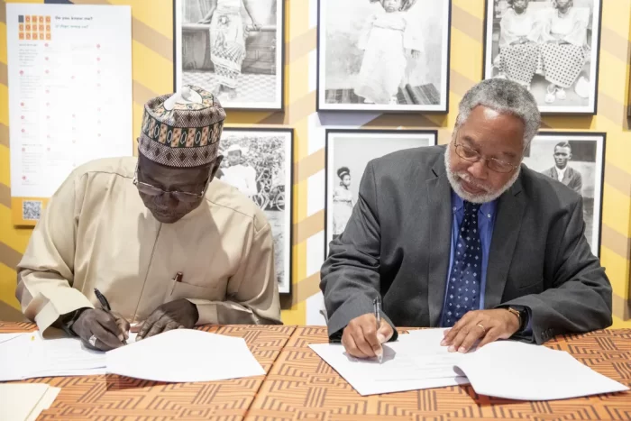 Getty image of Bunch and Lai Mohammad signing an agreement