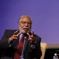 Getty image of Bunch on stage, gesturing with his hands as he talks