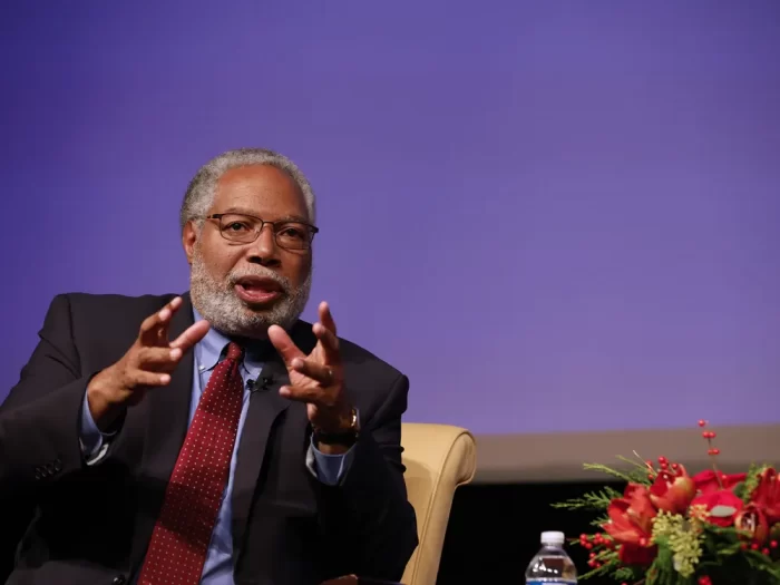 Getty image of Bunch on stage, gesturing with his hands as he talks