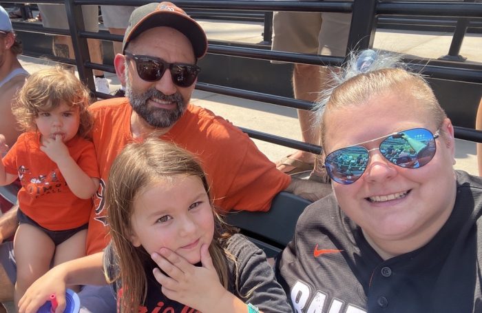 Family photo of Baldioli, husband, two young girls