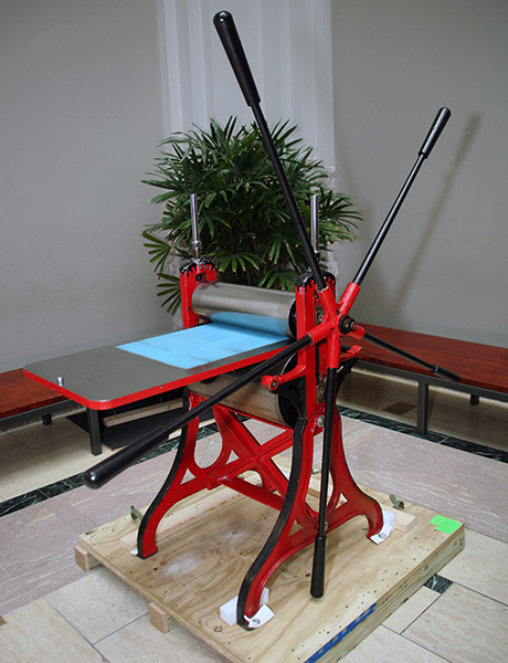 Red printing press with unusually long handles