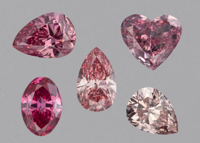 Five diamonds with of different cuts in shades of pink