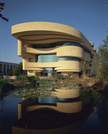 East entrance of the Smithsonian's National Museum of the American Indian in Washington, D.C., with wetlands in the foreground.