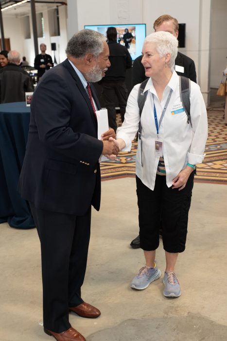 Secretary Bunch shakes hands with white-haired woman